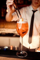 Barman is making cocktail at night club