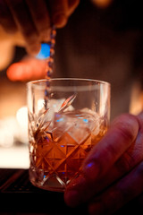 Barman is making cocktail at night club