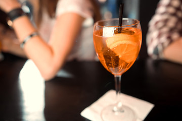 Classic Manhattan alcoholic cocktail served in a glass with a slice of orange peel