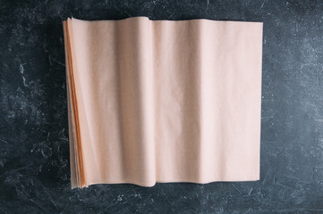 Baking paper on a dark background. Top view