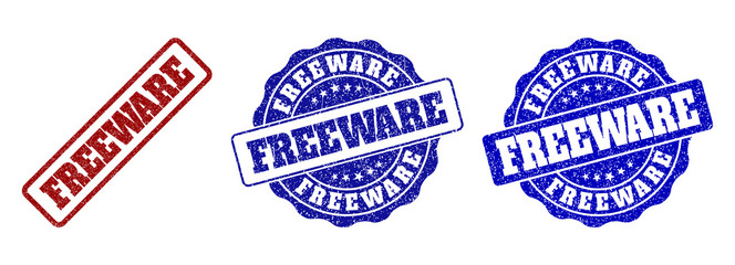 FREEWARE grunge stamp seals in red and blue colors. Vector FREEWARE labels with scratced surface. Graphic elements are rounded rectangles, rosettes, circles and text labels.