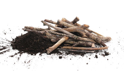 Soil, dirt pile with twigs, branches isolated on white background