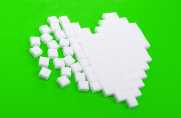 Broken heart made of sugar cubes