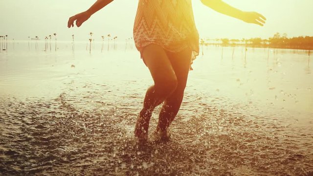 Young woman in short dress running on the beach during beautiful sunset. slow motion. 1920x1080, hd