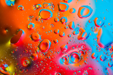 Colorful abstract background. Water drops colors on glass. Amazing abstract water drops on glass texture or background. Blue, red and orange abstract background