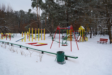 View of the Playground near the winter forest.