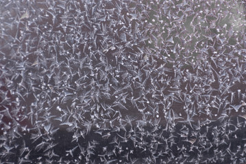 Frozen window ice pattern texture, snowflakes. Abstract icy festive background. Close-up. Soft focus