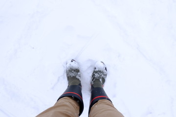 Many Snow on the boots. Winter day.