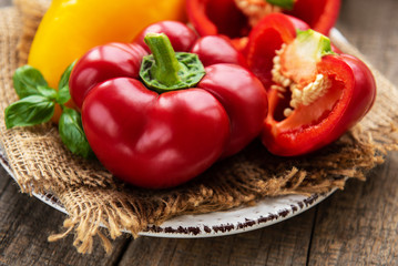 Plate with Bell peppers on a wooden background