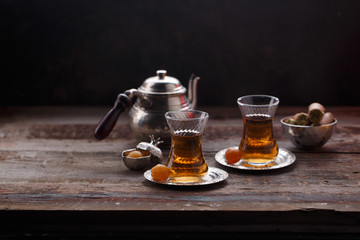 Traditional Turkish tea with oriental sweets, rustic copy space.