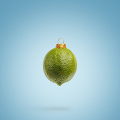 Juicy lime as a xmas ball. New Year concept.