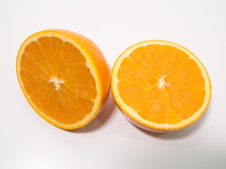 Sliced fresh orange cut in half on white background, overhead view