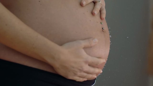 Pregnant Woman Cuddling Belly - slow motion