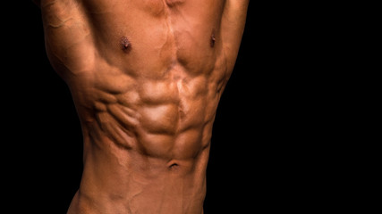 male torso over black background. Perfect abs and chest.