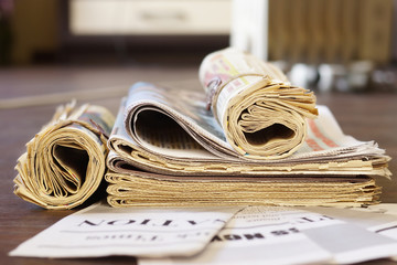 Newspapers and documents. Daily paper with news on wooden table. Pages with text, articles and...