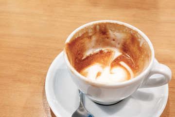 Hot coffee latte on a wooden table.