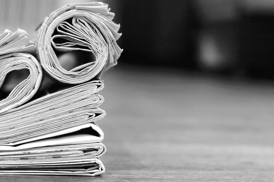 Business news template with stack of newspapers and magazines and empty space (copy space) for text