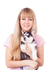 Happy women with her puppy Husky in the studio.