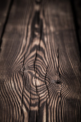 An old board with knots and chips. Wood. Background. Selective focus