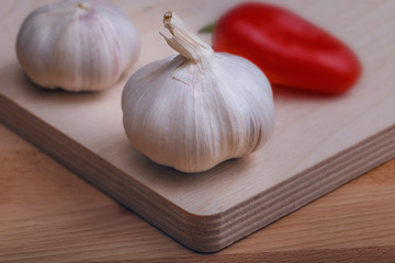 healthy eating concept. A few heads of garlic and pepper on a wooden background