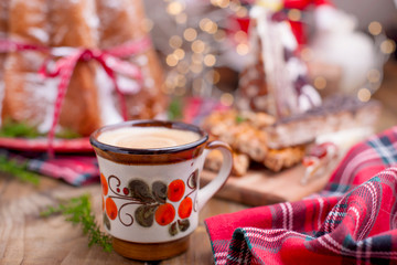 Christmas bread for a festive breakfast. on a wooden background and traditional festive winter sweets. Morning drink and nuts in caramel. Photo tinted. Top view.