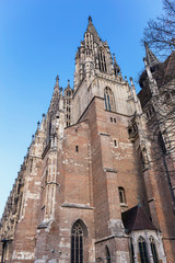 Fototapeta premium bottom view of a fragment of the cathedral on the blue summer sky background.