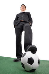 Business man and his leather ball.