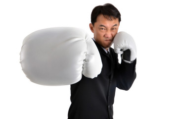Businessman wearing boxing gloves acting  punching like business have competition all time