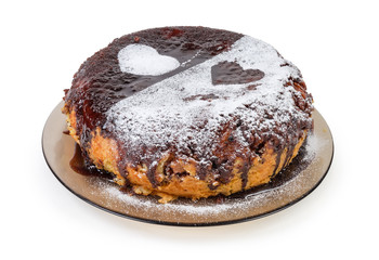 Cake covered with chocolate glazing, powdered sugar and hearts signs