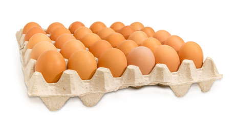 Brown eggs in the cardboard egg tray at selective focus