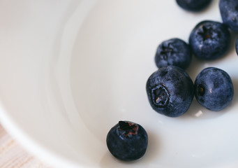 Fresh blueberries in white bowl macro closeup