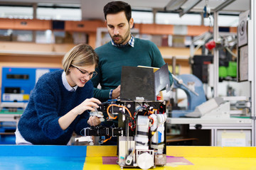 Young students of robotics working on project
