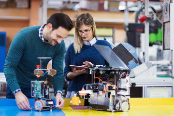 Young students of robotics working on project