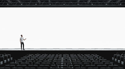 Presentation hall with person on scene auditorium blank screen mockup