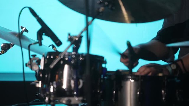 Drummer playing the drums during a live show.
