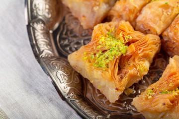 Turkish sweets baklava and metal oriental tray on wooden background