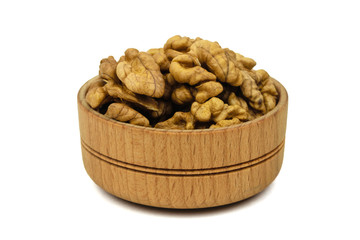 Split walnuts in wooden Cup isolated on white background.