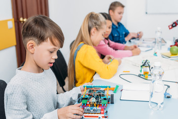 focused children working together on STEM project in classrom