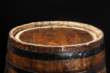 Old wooden barrel on a dark background