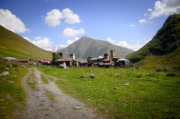Village Ushguli landscape with massive rocky mountains Bezengi wall, Shkhara on the background in Svaneti, Georgia