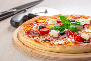 Pizza with Mozzarella, Ham, Cherry Tomatoes, Black Olives
