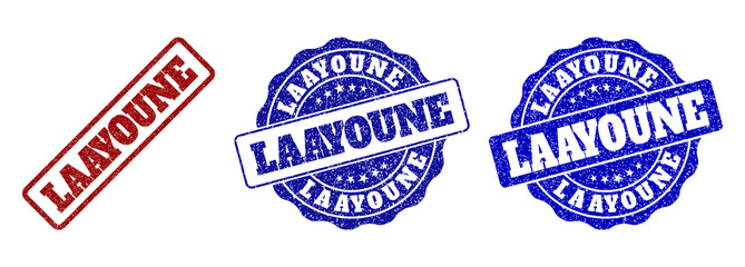 LAAYOUNE scratched stamp seals in red and blue colors. Vector LAAYOUNE labels with grunge surface. Graphic elements are rounded rectangles, rosettes, circles and text labels.