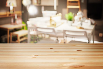 a wooden table with background of blurry interior living room at modern house