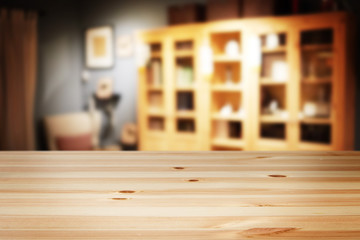 a wooden table with background of blurry interior living room at modern house