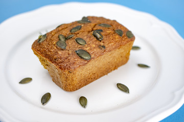 Gluten-Free pumpkin bread with pumpkin seed in white plate.