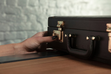 secretary tries to decipher the closure in the briefcase