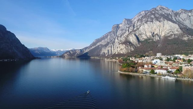 Boat on the lake and city of Lecco. 
Lake of Como in Italy, Famous tourist destination in Europe