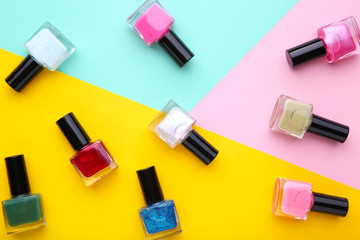 Group of bright nail polishes on colorful background