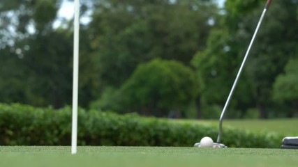 Business guy playing golf.