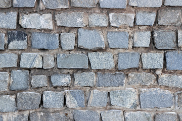 Wall of old granite stone